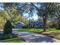 Curving driveway showcasing a home with tree-lined landscape at 2614 W Ponkan Rd, Apopka, FL 32712