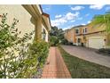 Brick walkway lined with lush landscaping leads to home at 26148 Avenida Las Colinas # 3B, Howey In The Hills, FL 34737