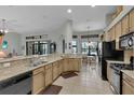 Modern kitchen with granite countertops, ample cabinetry, and stainless steel appliances at 27238 Stoney Brook Dr, Leesburg, FL 34748