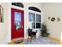 Charming front porch with red door and potted plants at 27527 Briar Patch Pl, Leesburg, FL 34748