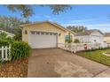 Exterior shot of the home, highlighting the two-car garage and well-maintained driveway at 2821 Barboza Dr, The Villages, FL 32162