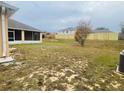 View of backyard, featuring a screened patio and a fence at 3236 White Blossom Ln, Clermont, FL 34711