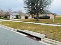 House exterior view, showcasing front yard and street at 3236 White Blossom Ln, Clermont, FL 34711