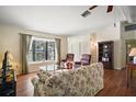 Living room with hardwood floors, bay window, and comfortable seating at 401 Cherry Tree St, Eustis, FL 32726