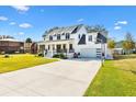 White farmhouse with driveway, basketball court, and detached structure at 4777 Cr 306A, Lake Panasoffkee, FL 33538