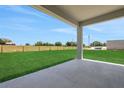 Covered patio offering serene views of the expansive backyard, blending indoor/outdoor living seamlessly at 5095 Firebush Dr, Apopka, FL 32712