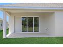 Covered patio with sliding glass doors, perfect for enjoying the outdoors in comfort at 5131 Firebush Dr, Apopka, FL 32712