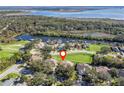 Home's location highlighted in an aerial view by a lake at 6220 Topsail Rd, Lady Lake, FL 32159