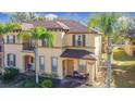 Two-story townhome with palm trees and walkway at 647 Calabria Ave, Davenport, FL 33897