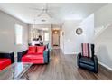 Living room with red couches and wood-look floors at 647 Calabria Ave, Davenport, FL 33897