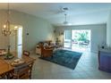 Living room with leather couch, wicker chairs, and access to a patio at 670 Murphys Estate Dr, The Villages, FL 32162