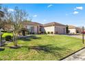 House with a two-car garage and well-maintained lawn at 9565 Se 124Th Loop, Summerfield, FL 34491