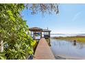 Private dock with covered boat lift and stunning lake views at 9724 Rosemary Ln, Leesburg, FL 34788