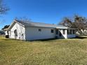 Side view of the house, highlighting the sunroom and lawn at 10173 Se 175Th Ln, Summerfield, FL 34491