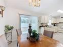 Dining area with wood table, access to the kitchen and backyard at 11267 Sw 62Nd Avenue Rd, Ocala, FL 34476