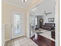 Entryway with glass door and view of living room with hardwood floors at 12413 Se 176Th Loop, Summerfield, FL 34491