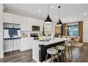 Modern kitchen with white cabinets, island, and stainless steel appliances at 13233 Peaceful Melody Dr, Winter Garden, FL 34787