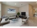 Open living room featuring L-shaped sofa, large TV, and stylish decor at 13237 Peaceful Melody Dr, Winter Garden, FL 34787