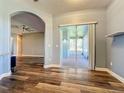 Dining room with wood-look flooring, access to screened patio, and archway at 163 Crepe Myrtle Dr, Groveland, FL 34736