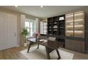 Modern home office with built-in shelving and a large work desk at 16369 Ingram Hills Aly, Winter Garden, FL 34787