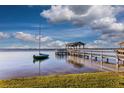 Peaceful lakefront property featuring a private dock and sailboat at 1735 Lakeshore Dr, Mount Dora, FL 32757