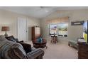 Cozy sitting room with a comfortable sofa and large window at 1918 Yankee Clipper Run, The Villages, FL 32162