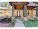 Inviting front porch with stone pillars and a wooden ceiling at 2187 County Road 243C, Wildwood, FL 34785