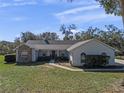 House exterior with stone facade and manicured lawn at 23720 Sundance Dr, Sorrento, FL 32776