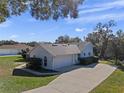 View of home's side showcasing garage and landscaping at 23720 Sundance Dr, Sorrento, FL 32776