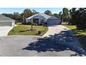 Single-story house with a two-car garage and corner lot view at 24308 Belle Mede Dr, Leesburg, FL 34748