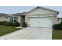 Front view of a house with a white garage door at 29320 Armoyan Blvd, Leesburg, FL 34748