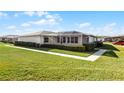 Back view of the house, showing a screened patio and landscaping at 2941 Tangerine Ct, Leesburg, FL 34748