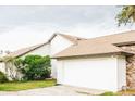 White garage door with stone and siding accents at 31 Sand Lake Pl, Eustis, FL 32726