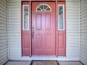 Eye-catching coral front door with sidelights and etched glass at 32622 Oak Park Dr, Leesburg, FL 34748