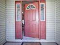 Open coral front door offering a view of the home's interior at 32622 Oak Park Dr, Leesburg, FL 34748