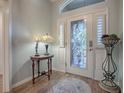 Elegant entryway with stained glass door and hardwood floors at 3281 Bell Ter, The Villages, FL 32163