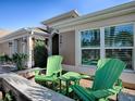 Inviting front porch with green Adirondack chairs at 3281 Bell Ter, The Villages, FL 32163