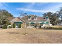 Inviting home with a covered porch, dormer windows, and well-maintained landscaping at 37008 Shalimar Dr, Fruitland Park, FL 34731