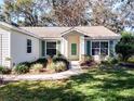 House front entrance with green door and landscaping at 3716 Plantation Blvd, Leesburg, FL 34748