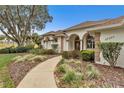 House exterior showcasing a walkway and neatly manicured landscaping at 39335 Harbor Hills Blvd, Lady Lake, FL 32159