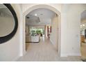 Bright and airy foyer with a view to the living room and kitchen at 4038 Swaying Palm Ct, The Villages, FL 32163