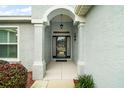 Elegant entryway with arched doorway and stylish light fixture at 4557 Antietam Creek Trl, Leesburg, FL 34748