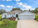 Stunning curb appeal with a three-car garage and lush landscaping at 4557 Antietam Creek Trl, Leesburg, FL 34748