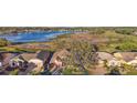 An aerial view of the single-story home showing a great view of the lake and golf course at 4822 Sawgrass Lake Cir, Leesburg, FL 34748