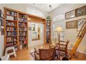 View of the library with floor to ceiling bookshelves, hardwood flooring, and stylish decor at 4822 Sawgrass Lake Cir, Leesburg, FL 34748