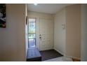 Light and airy entryway with a bench and tile flooring at 601 Waterwood Dr, Yalaha, FL 34797