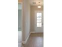 Light-filled entryway with wood-look tile flooring at 10049 Ballast Dr, Orlando, FL 32827