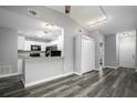 Modern kitchen with white cabinets, granite counters, and black appliances at 1015 Stucki Ter, Winter Garden, FL 34787