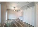 Open living area with gray walls, wood-look floors, and a ceiling fan at 1015 Stucki Ter, Winter Garden, FL 34787