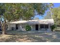 The exterior of this home features a covered entry and an attached garage at 11221 Lake Eustis Dr, Leesburg, FL 34788